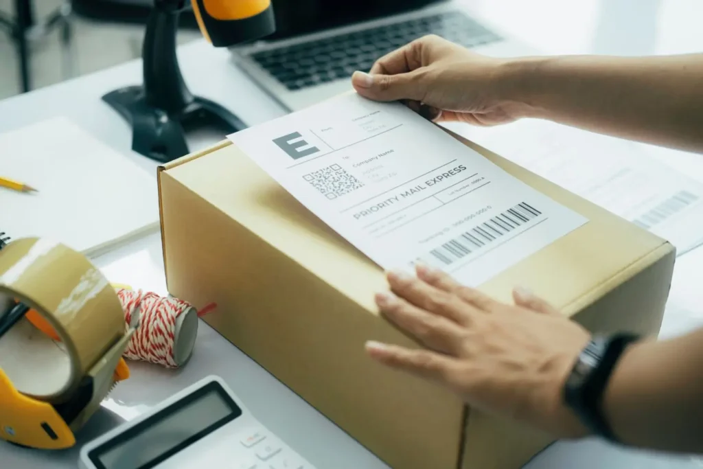 Small Business Owner Placing Shipping Label on a Parcel Ready to Ship