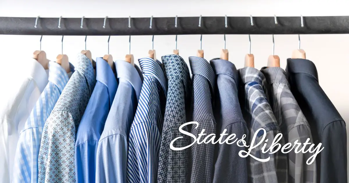 men’s athletic-fit dress shirts hanging in a closet with the State and Liberty logo displayed