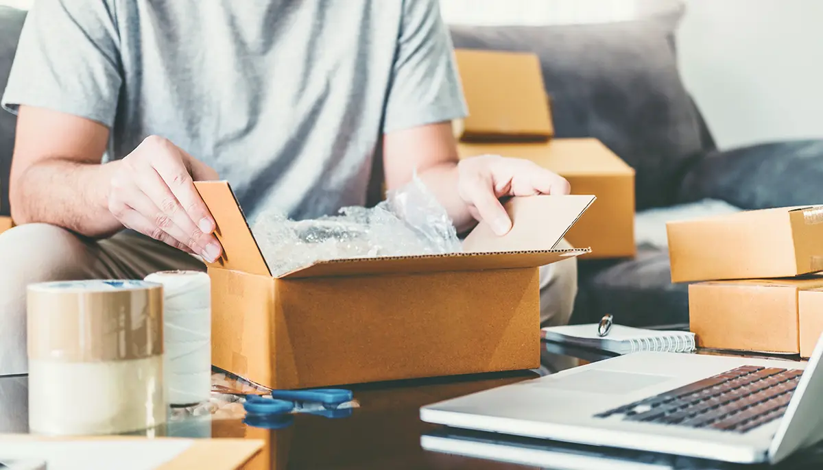 Ecommerce shipper packing a small, heavy package for shipping with USPS Priority Cubic